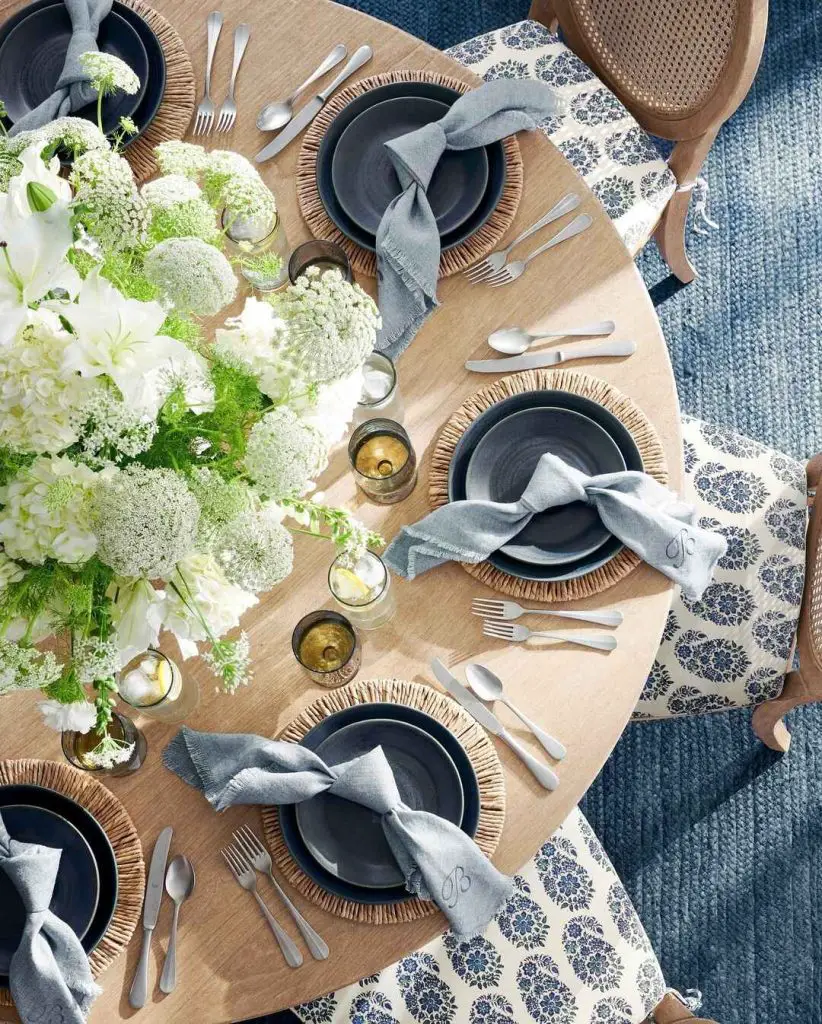 Elegant navy and natural table setting with white hydrangeas