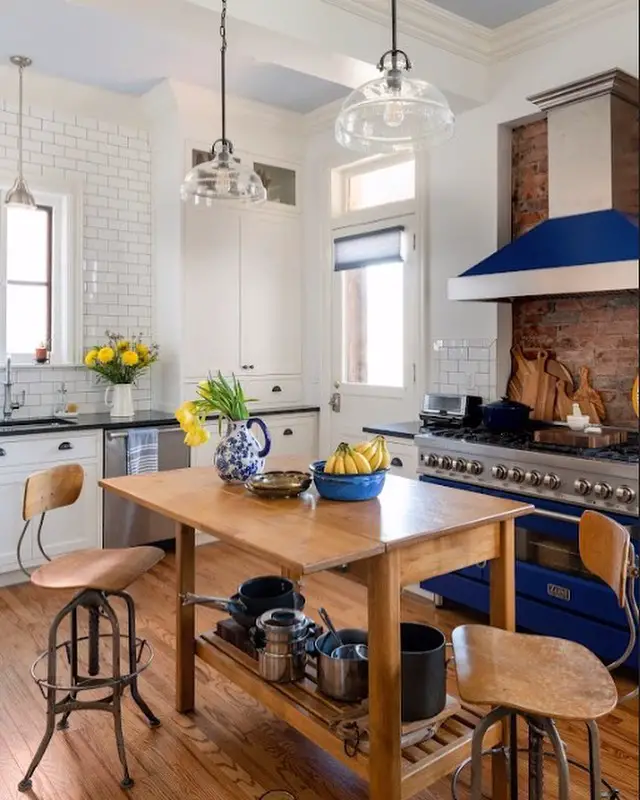 Kitchen with blue range and wooden prep table