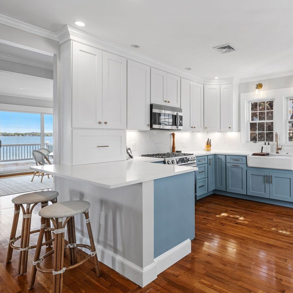 Mid-century kitchen with wooden beam ceiling and sage backsplash