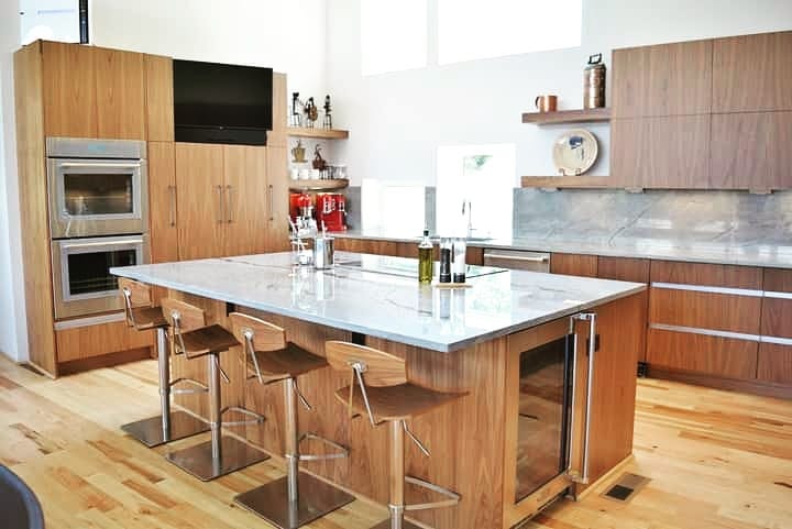 Modern walnut kitchen with marble island and tech features