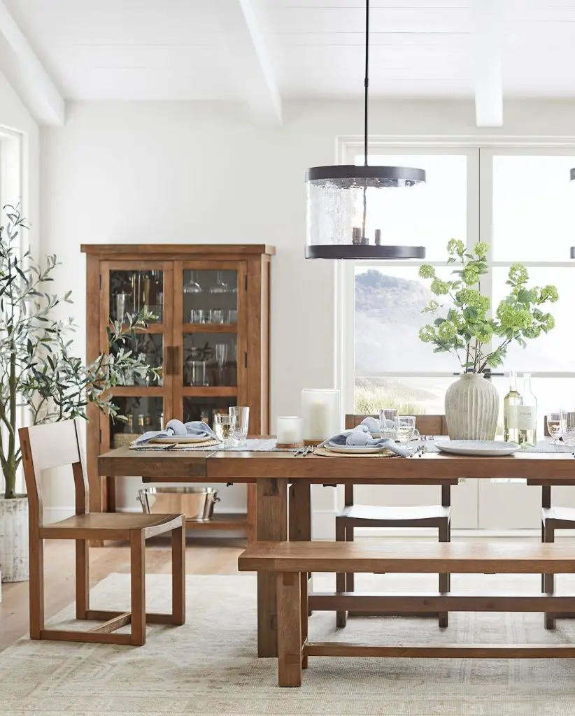 Modern farmhouse dining room with mountain views and wooden furniture