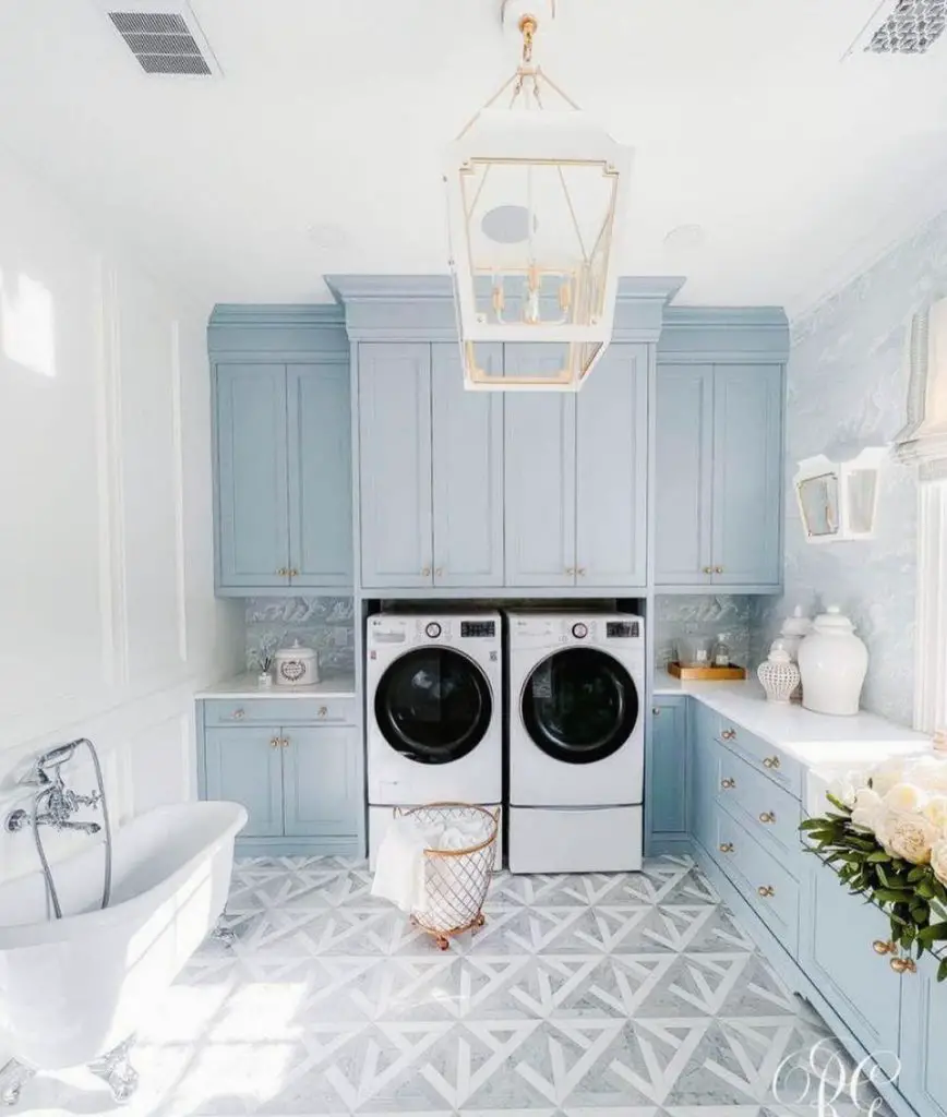 Luxurious blue-white laundry room featuring clawfoot tub