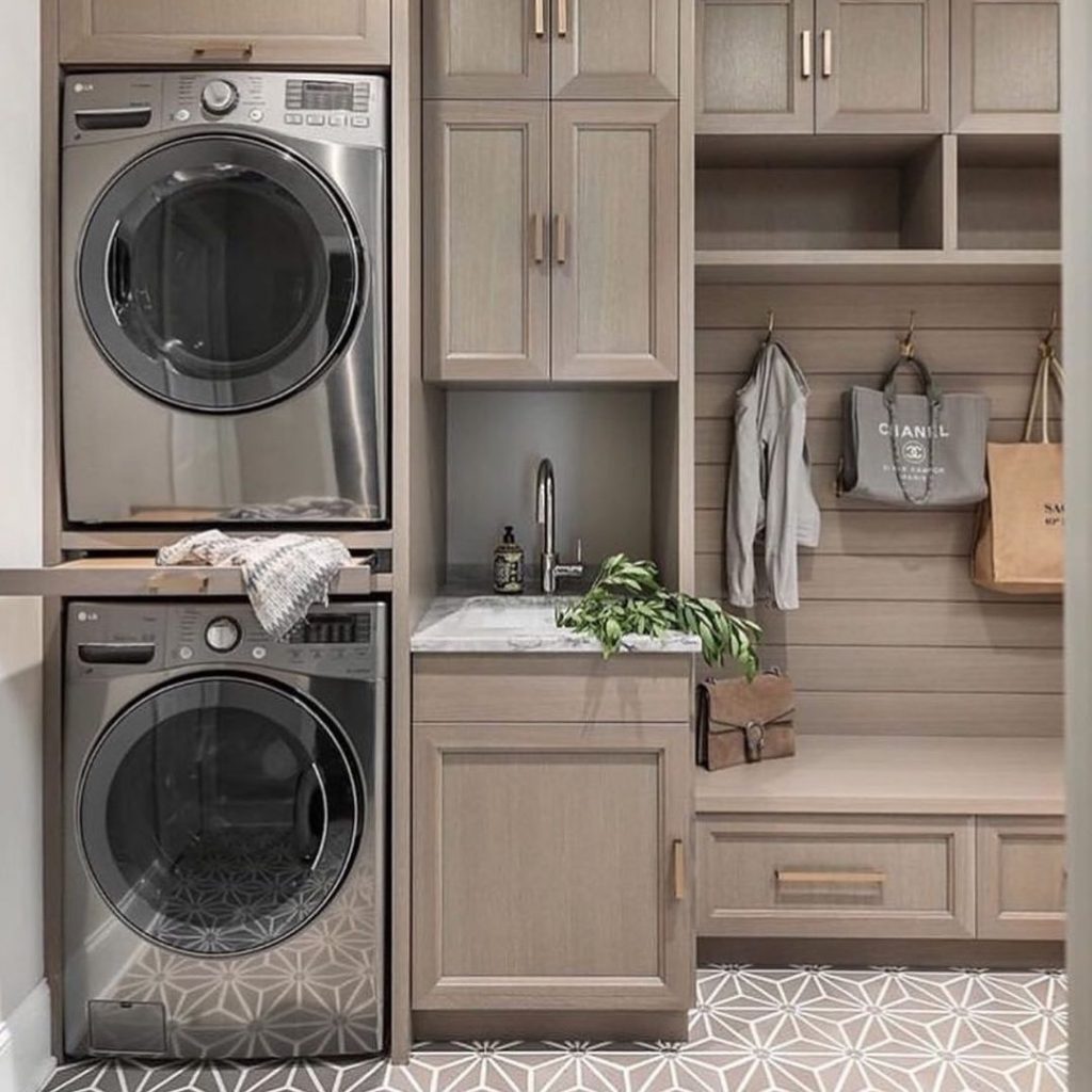 Greige laundry mudroom combo with stacked washers and geometric flooring
