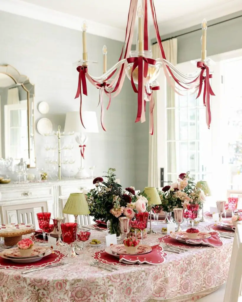 Elegant red and pink Valentine's table with ribbon-adorned chandelier