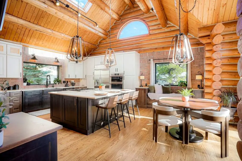 Cathedral ceiling kitchen with log walls and modern finishes