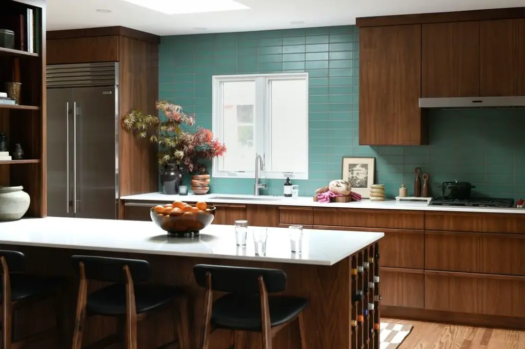 Walnut kitchen with aqua tile backsplash and modern island seating