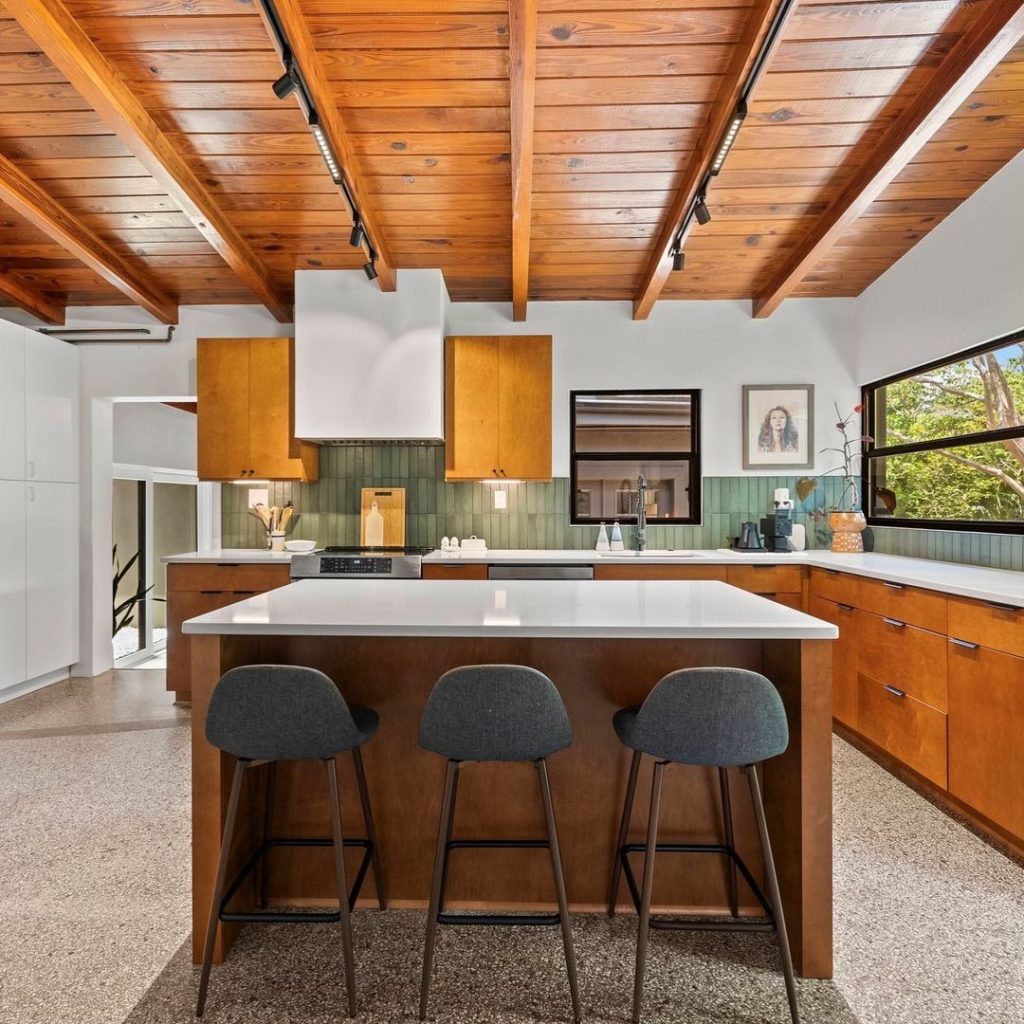 California modern kitchen with wood beams and sage tiles