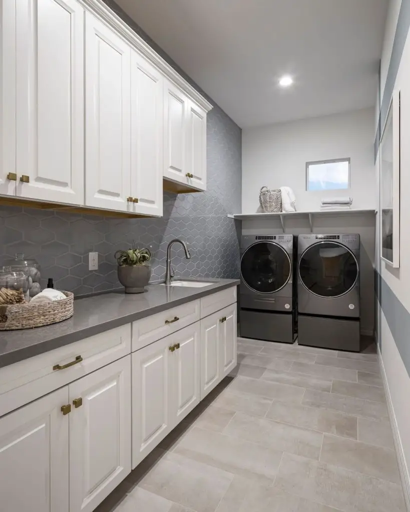 Modern galley laundry room white cabinets grey backsplash brass hardware