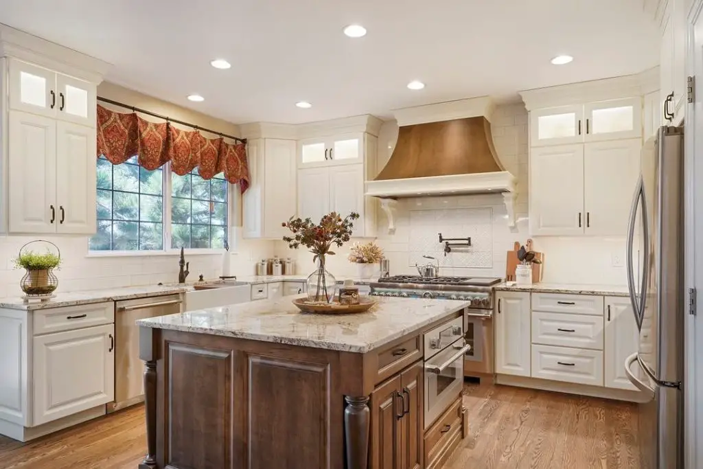 Bright modern kitchen with white cabinets and walnut island