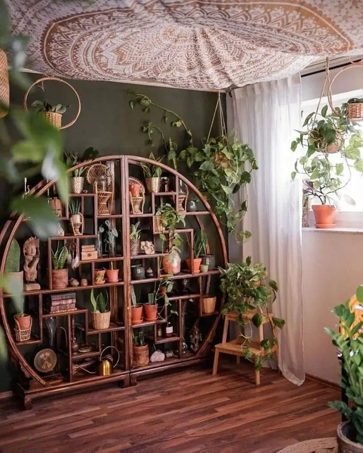 Round wooden shelf display with potted plants and spiritual decor under mandala ceiling tapestry