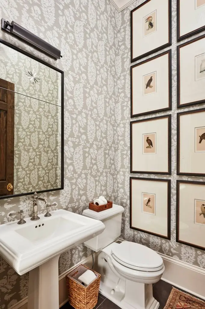 Traditional powder room with floral wallpaper and framed bird prints