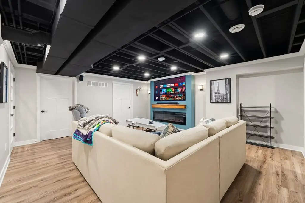 Coastal-inspired basement with TV setup.