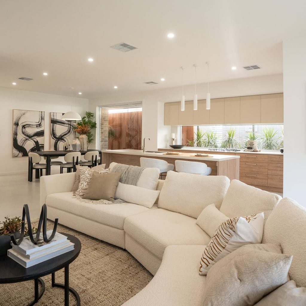 Modern open concept space with cream sofa and wood accents