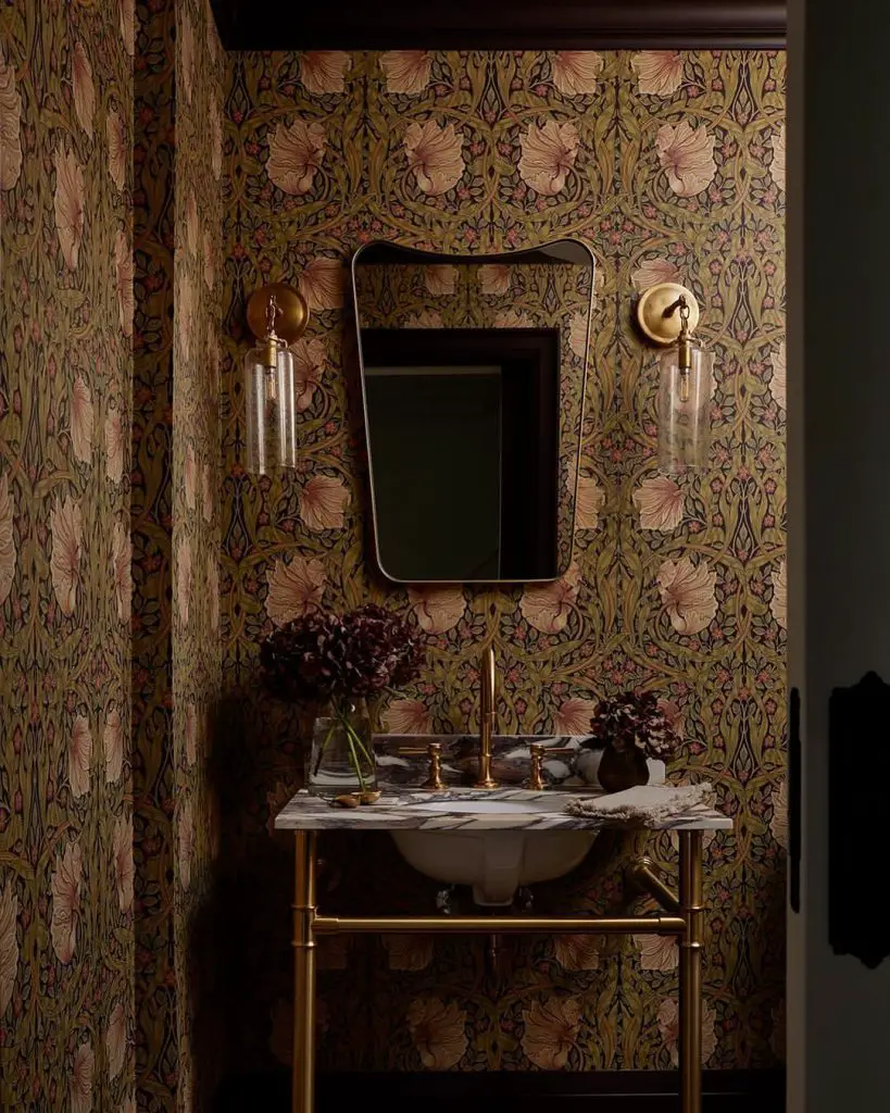 Powder room with floral print wallpaper and brass console sink