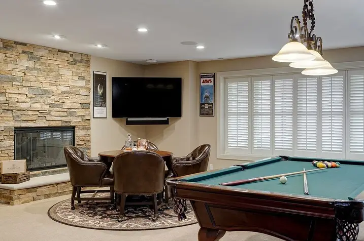 Monochrome basement TV room with modern design.