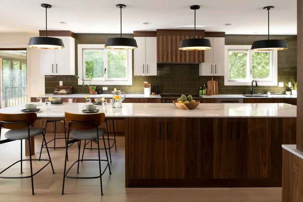 Modern open concept kitchen and living room with white counters and rattan barstools