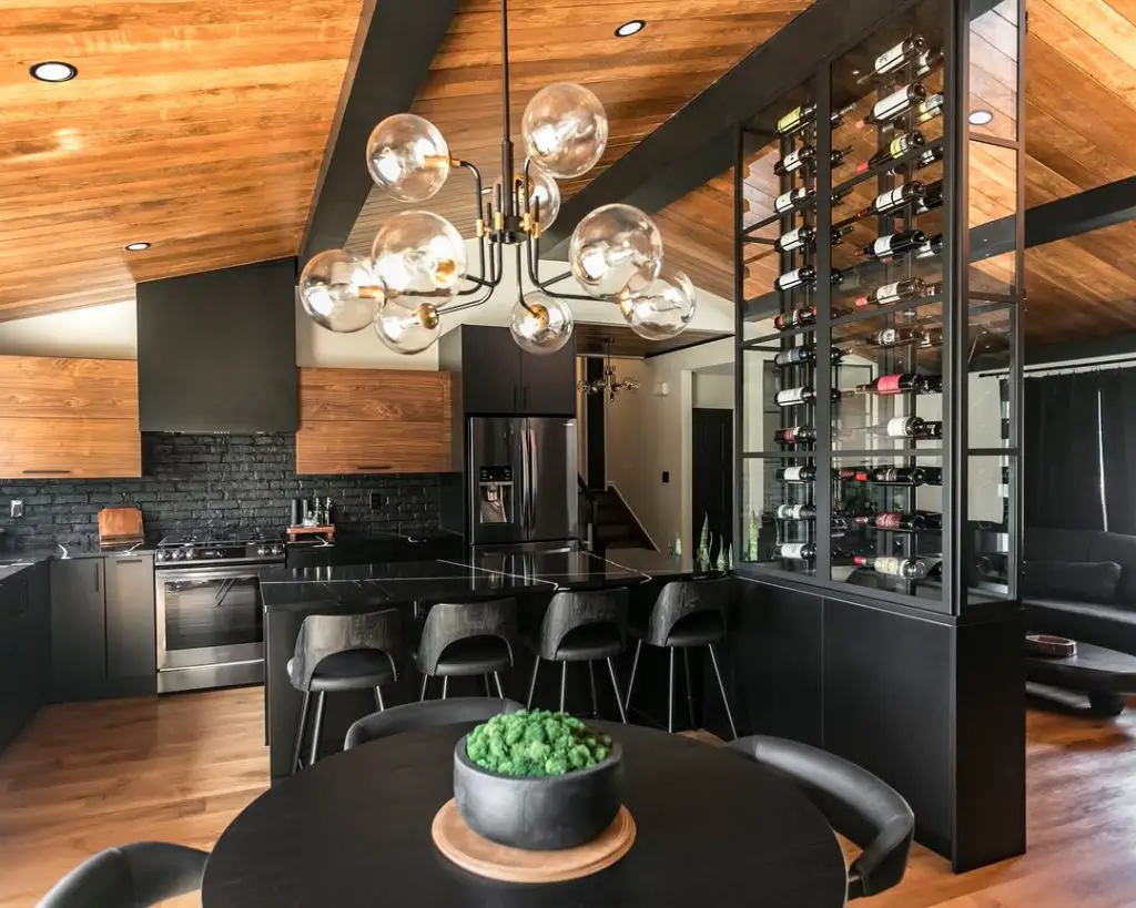 Dark modern kitchen with glass orb chandelier and wine wall