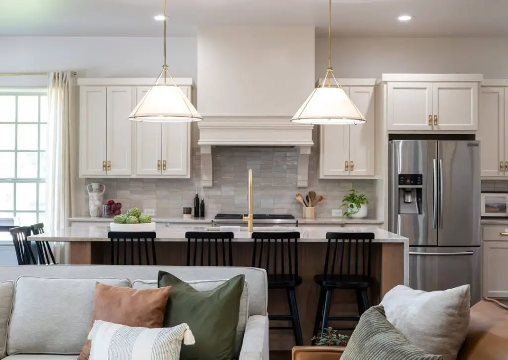 Elegant white kitchen flowing into cozy living area