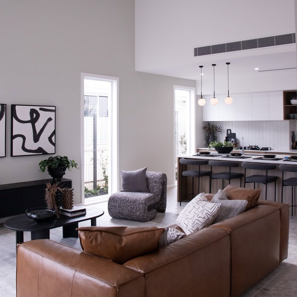 Modern open concept space with leather sofa and pendant lighting