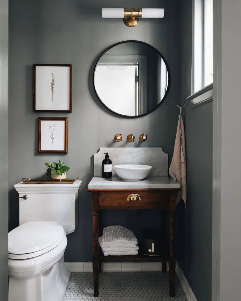 Traditional powder room with sage walls marble vanity and botanical artwork