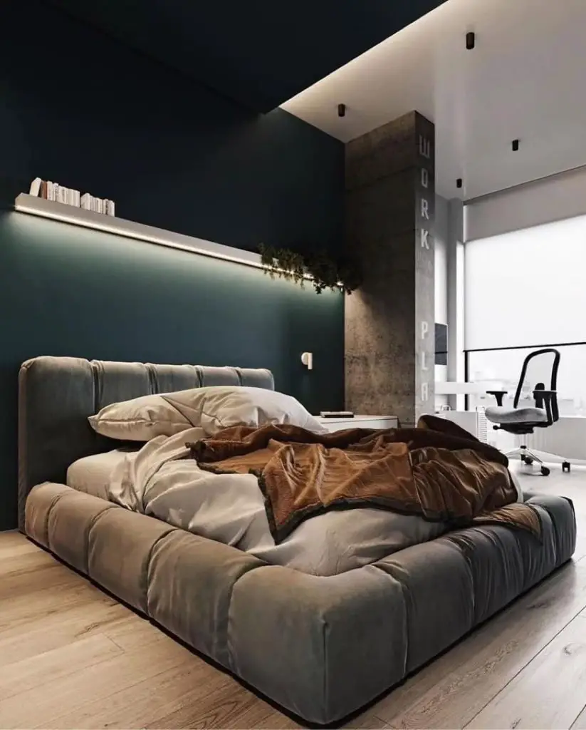 Industrial style bedroom with concrete walls wooden platform bed and orange artwork