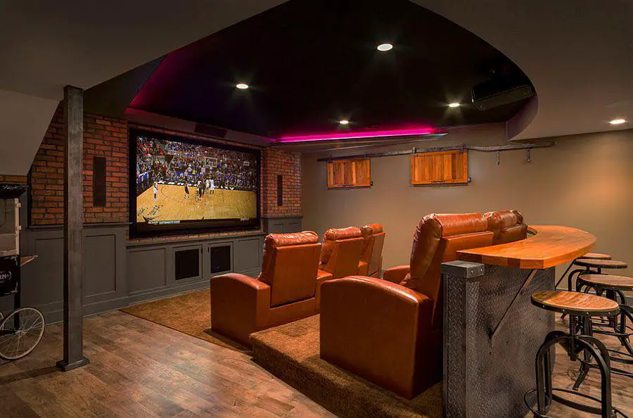Luxurious basement TV room with marble wall.