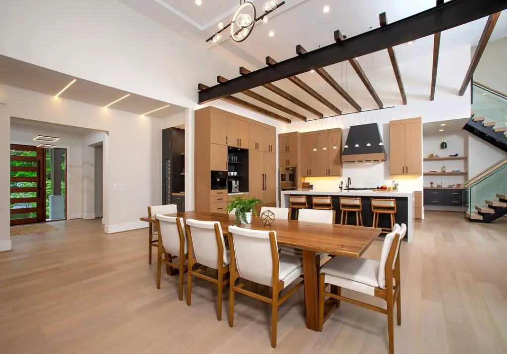 Spacious modern farmhouse kitchen with wooden beams and dining area