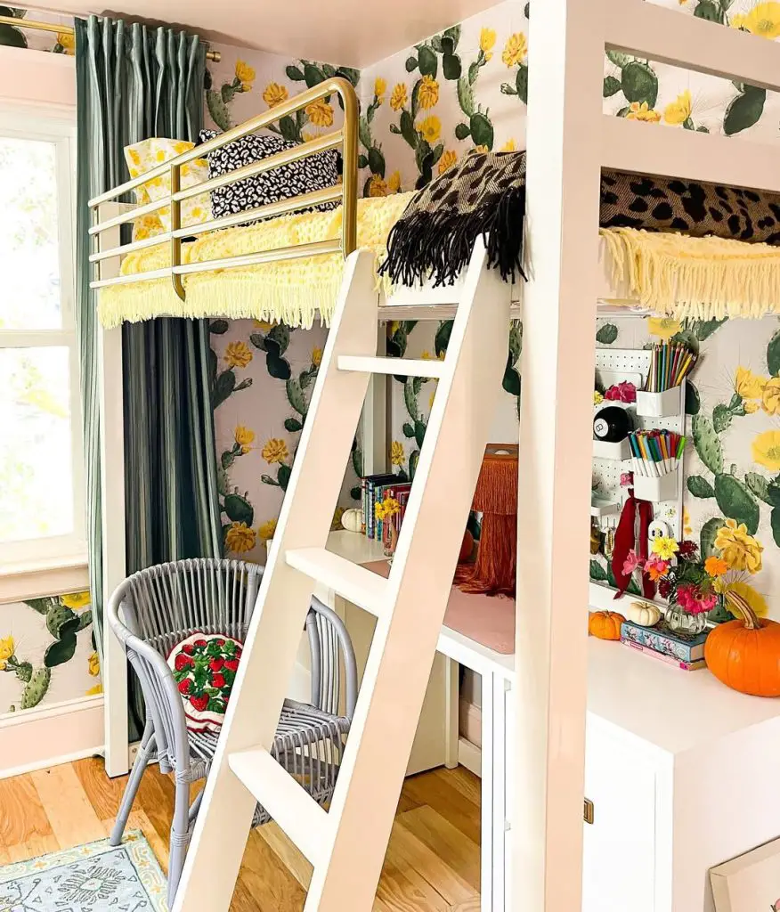 White loft bed with cactus wallpaper gold railings and gray wicker chair