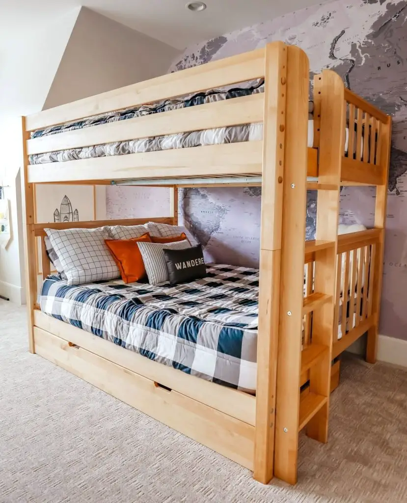 Wooden bunk bed with world map wall and patterned bedding