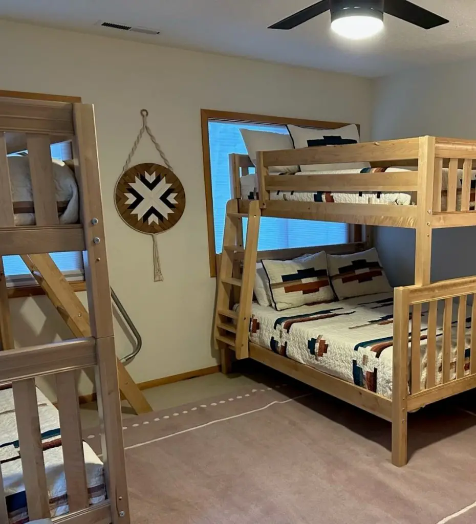 Wooden bunk bed with southwestern decor and patterned carpet below