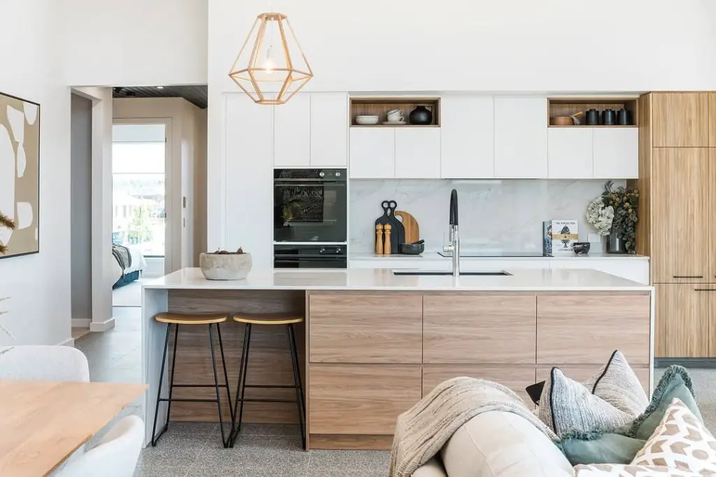 Modern minimalist kitchen with geometric lighting and wood accents