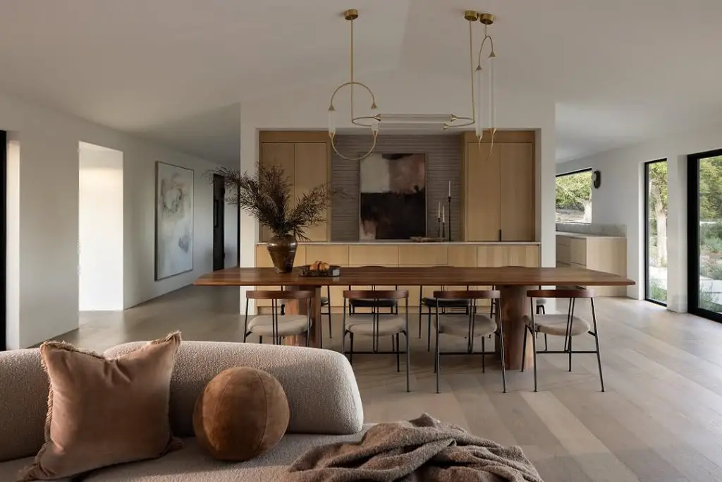 White minimalist kitchen featuring modern bar seating and clean lines