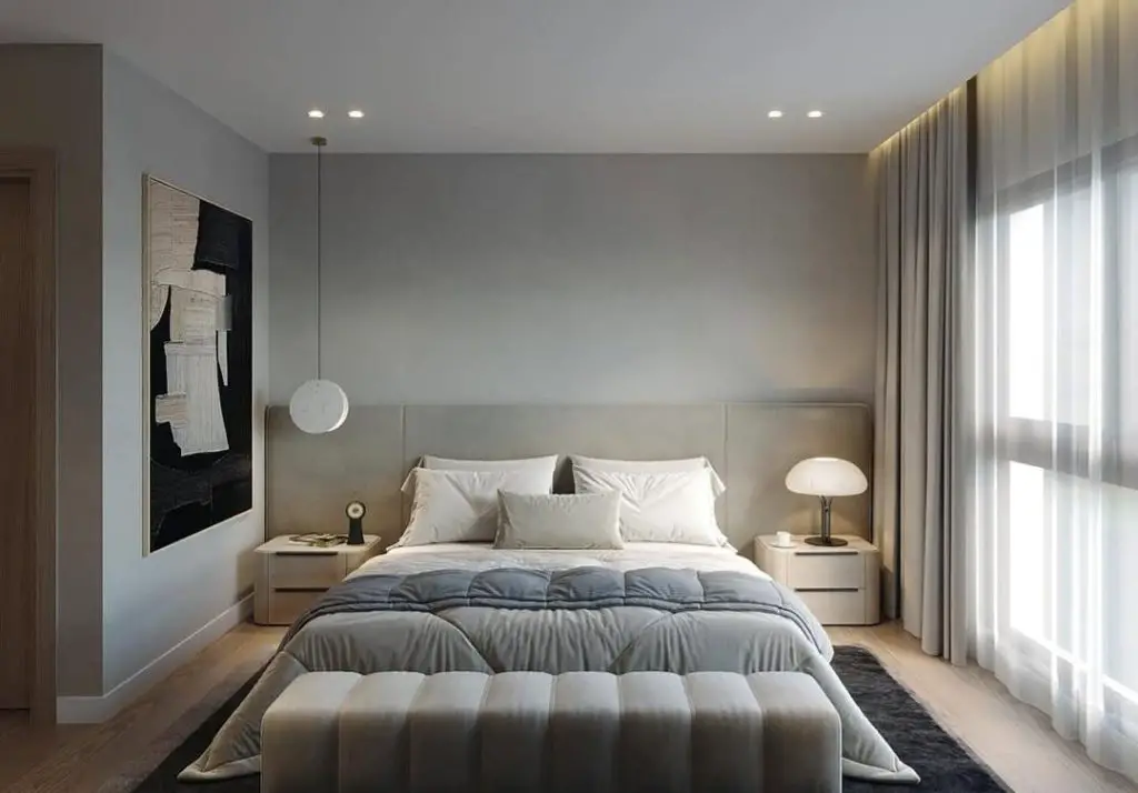 Minimalist grey bedroom with pendant light and abstract wall art