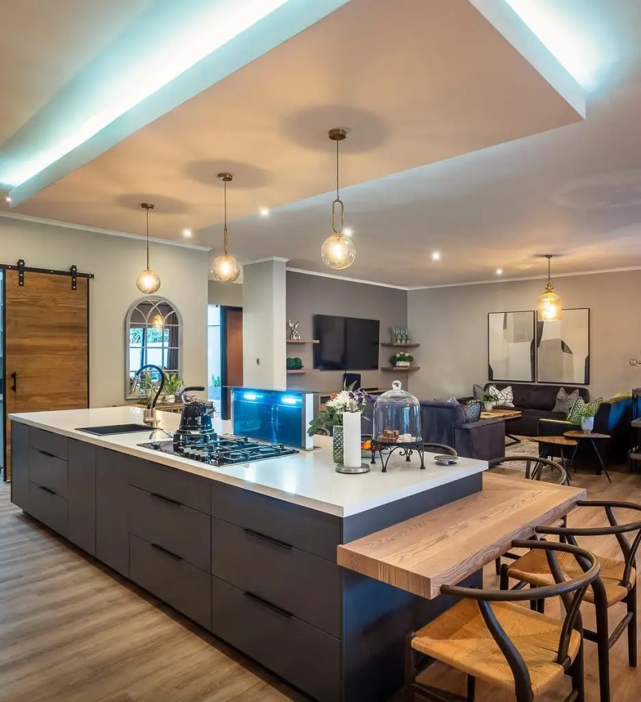Modern black kitchen with white island and wood accents
