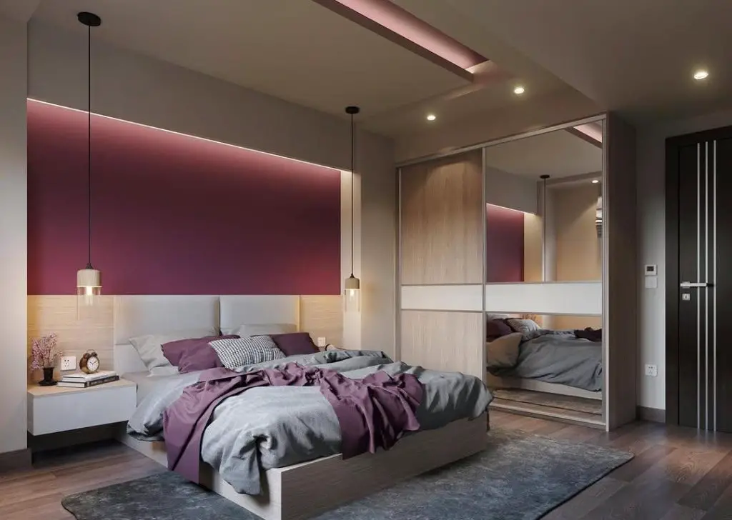Teen bedroom with built-in desk mountain mural and geometric bedding in gray and pink tones.
