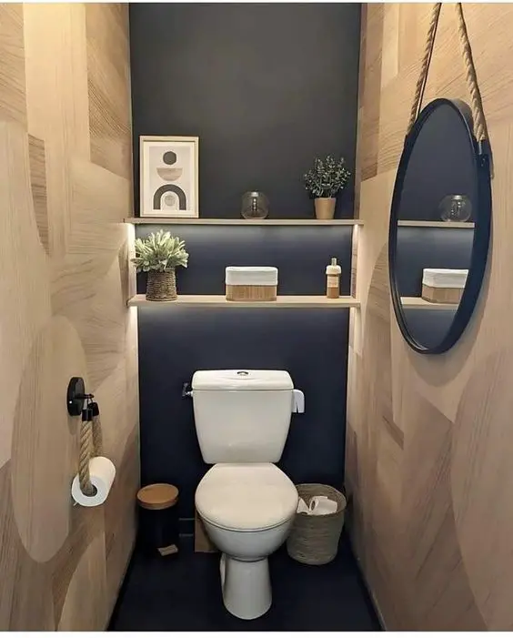 Modern powder room with wooden walls navy accent wall and floating shelves