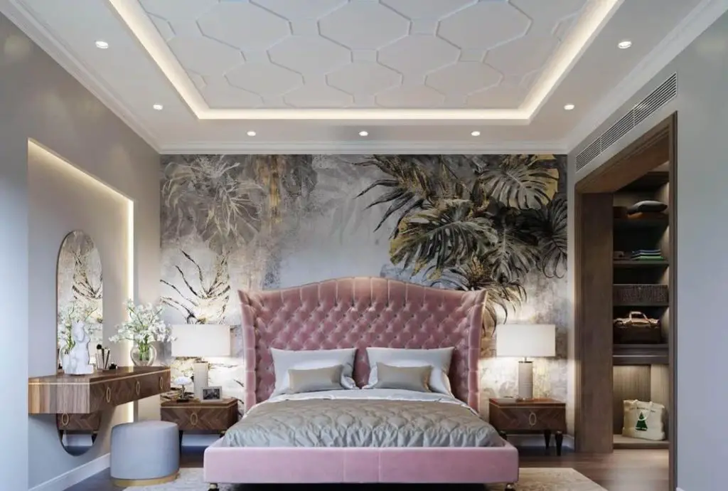 Modern bedroom featuring wooden accent wall white bedding and black pendant lights.