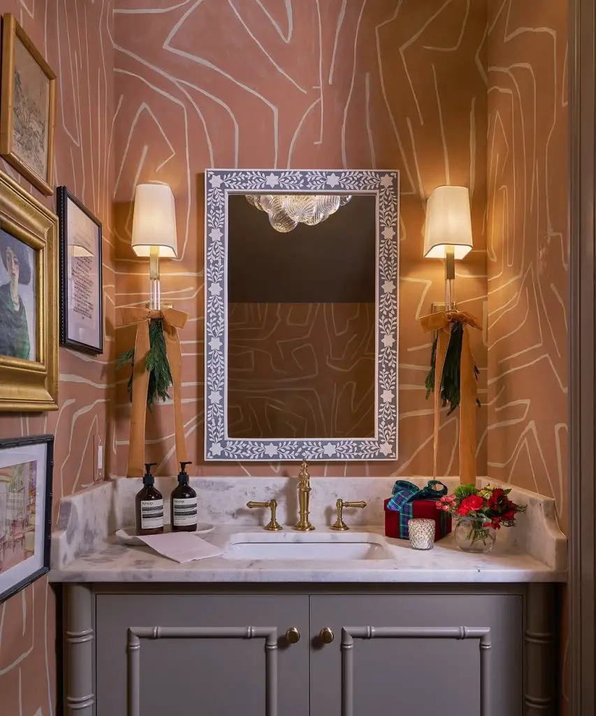 Pink powder room with white line wallpaper and floral accents