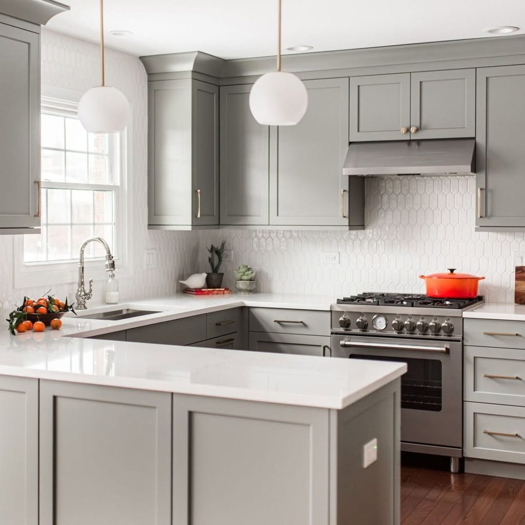 Sage green kitchen with modern geometric tiles