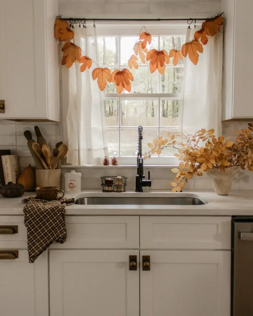 Autumn-inspired kitchen with farmhouse sink and leaf garland
