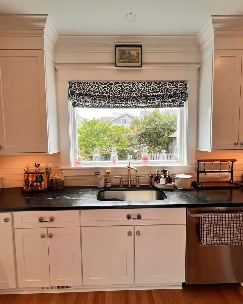 Bright kitchen with black countertop and floral valance