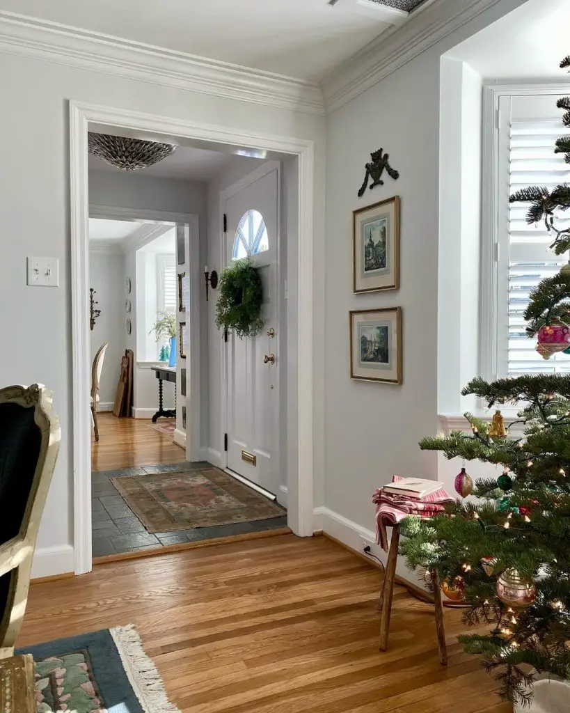 Charming hallway with a Christmas tree and decorated front door