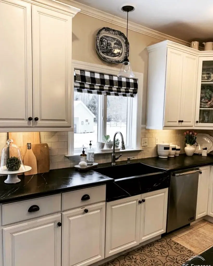 Charming kitchen with black countertop and white cabinetry