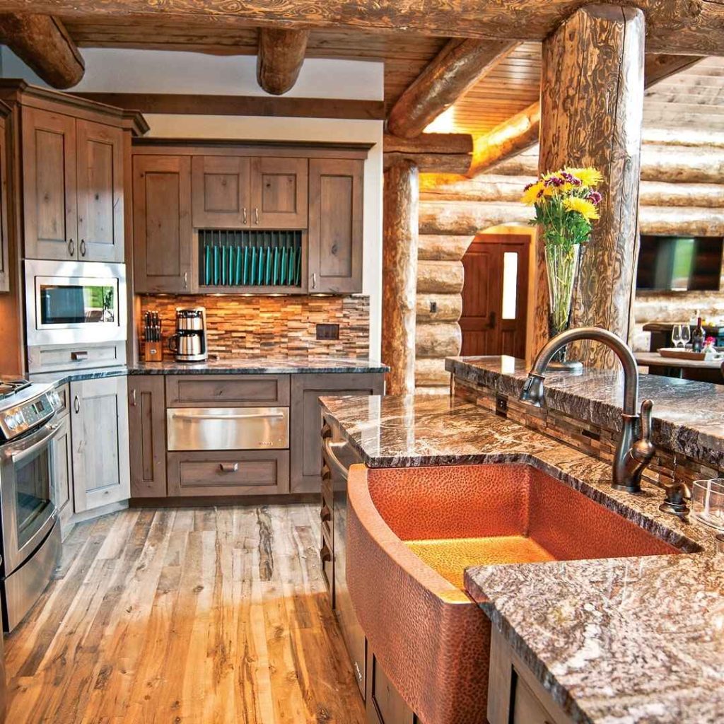 Charming log cabin kitchen with wooden cabinets, granite countertops, and a copper sink