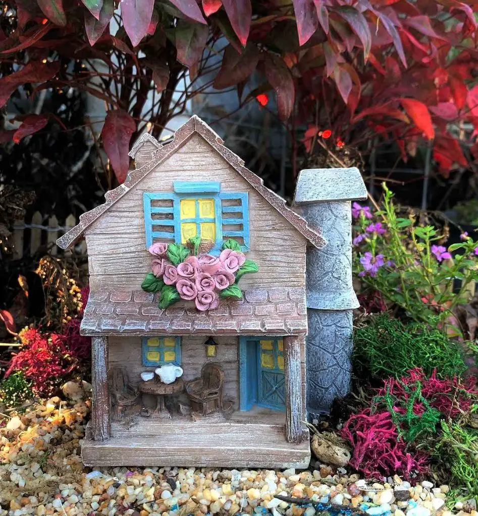 Miniature garden cottage with flowers
