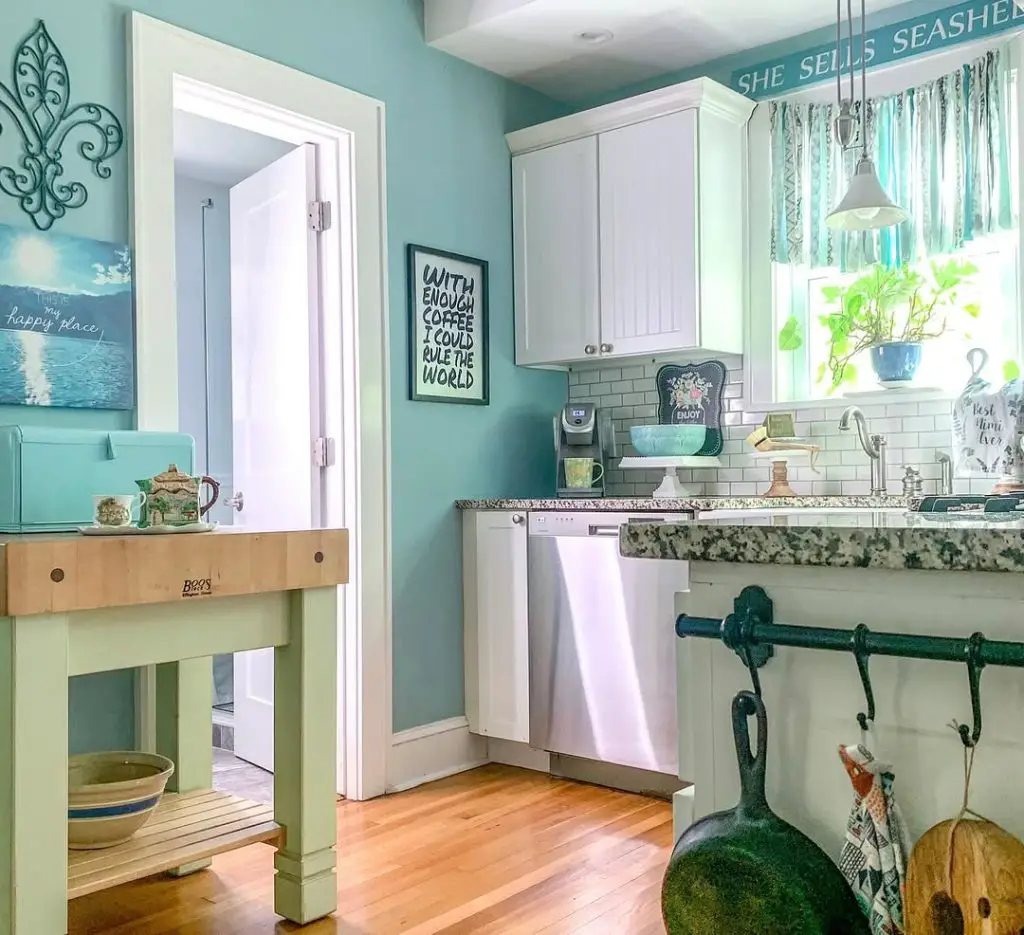 Cheerful coastal kitchen with aqua walls and white cabinetry