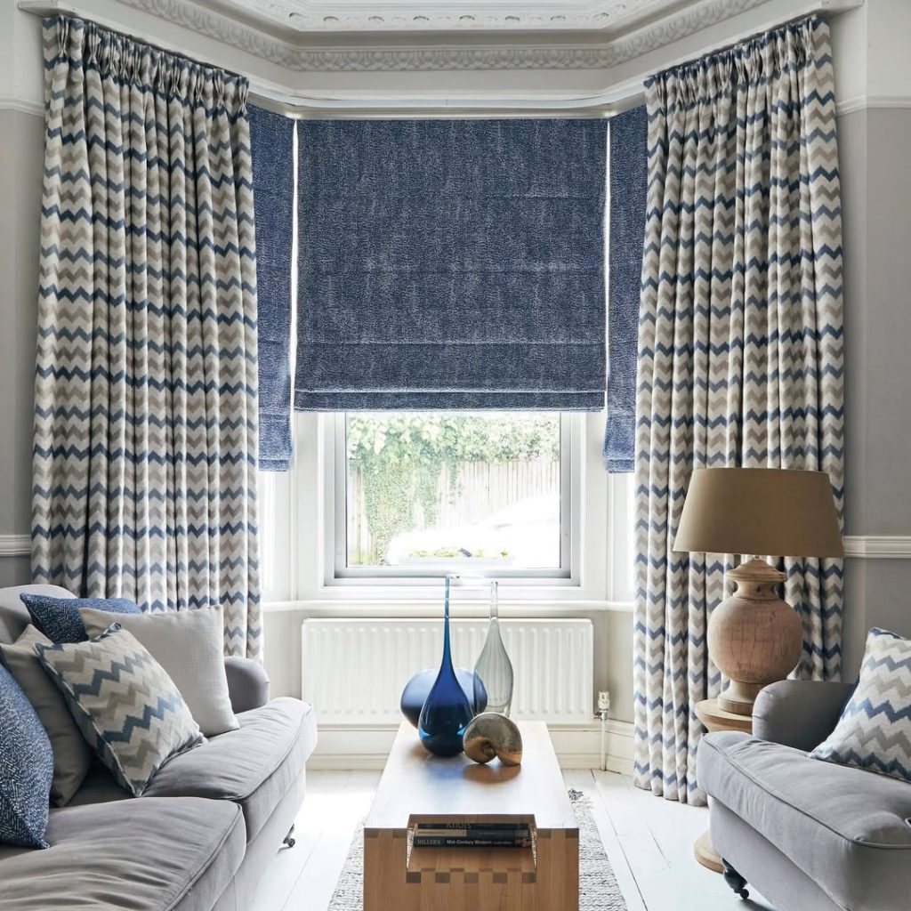 Living room with blue and beige chevron curtains and matching decor