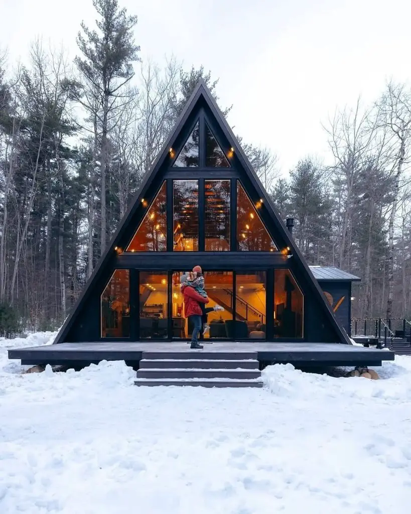 Stylish A-frame cabin surrounded by snow