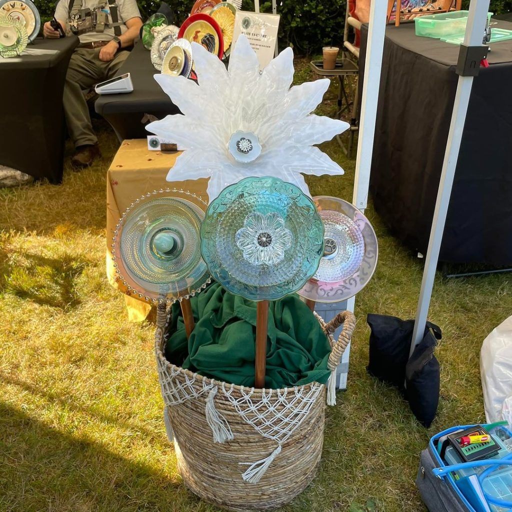 Decorative garden stakes with colorful glass plates in a woven basket