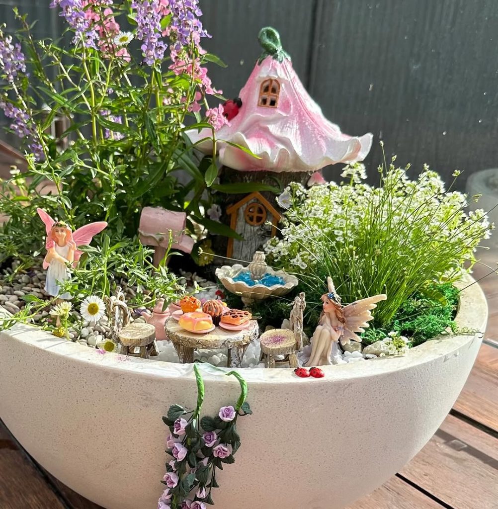 Fairy garden with mushroom house and flowers